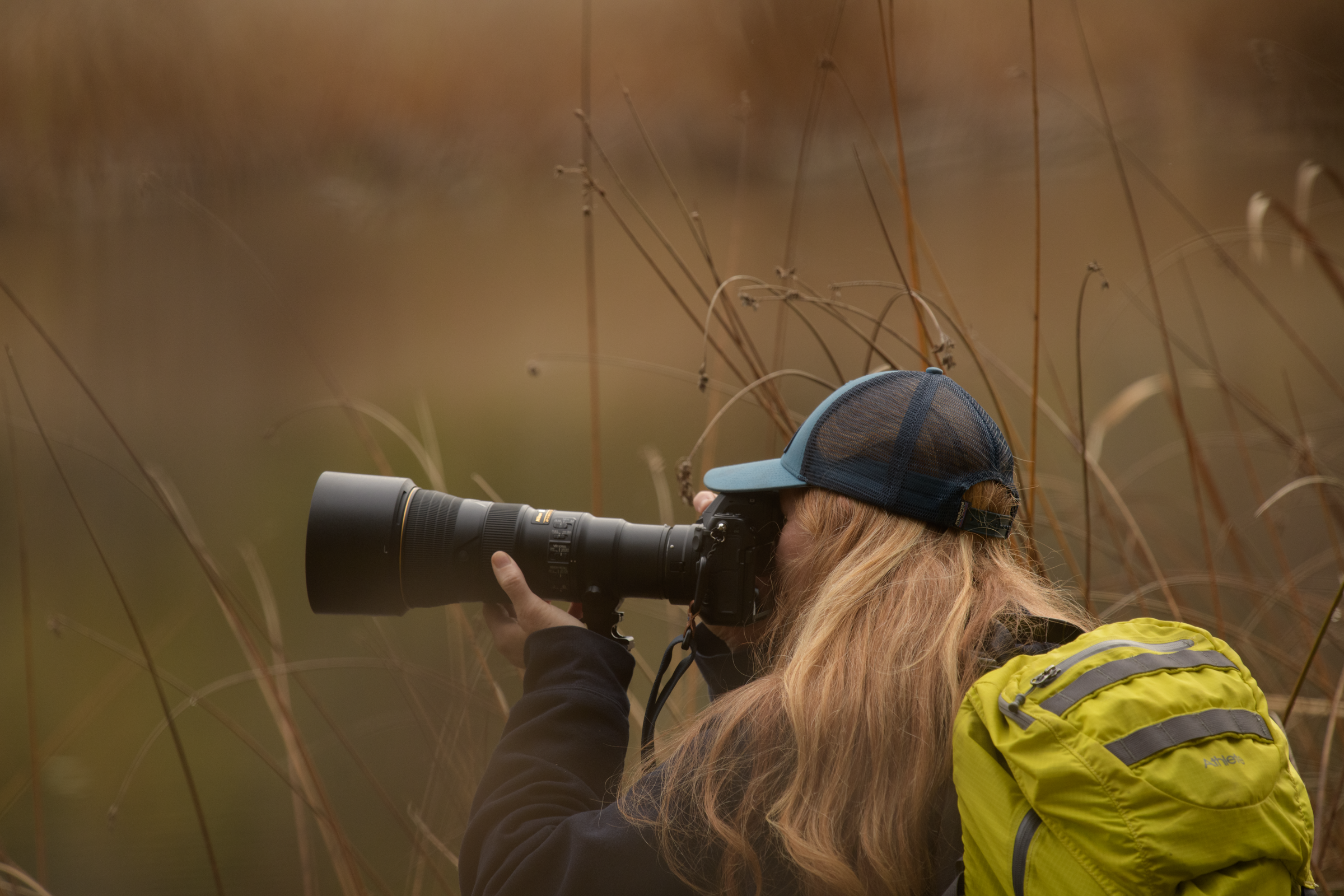 Karen Edwards, Conservation Photographer, taking image at lake in Fall. Washington State